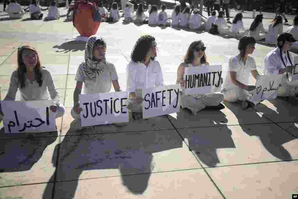 Women hold placards in Arabic, Hebrew, and English during a demonstration by Israeli and Palestinian women calling for peace, in Tel Aviv, Israel.