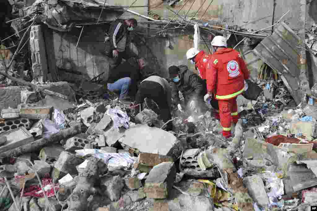 Paramedic workers search for victims in the rubble of a paramedic center that was destroyed by an Israeli airstrike in Hebbariye village, south Lebanon.