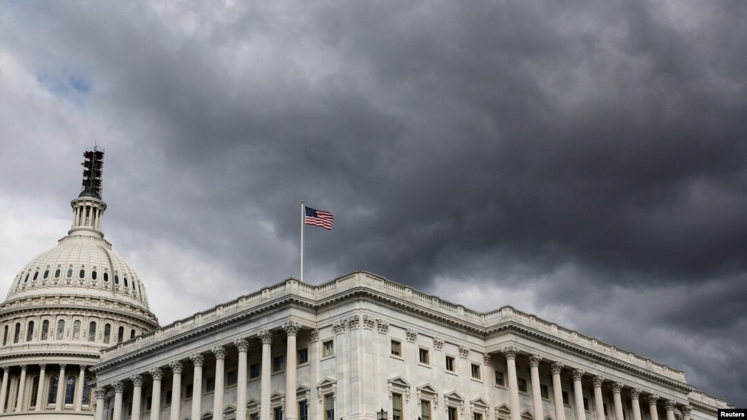 FILE - A cloud hangs over the US House of Representatives in Washington, Oct. 17, 2023.