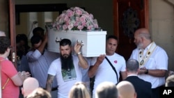 Pall bearers carry the coffin of stabbing victim Alice da Silva Aguiar after her funeral service at St. Patrick's Church in Southport, England, Aug. 11, 2024.