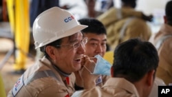 FILE - Workers from China Oilfield Services Limited, a contractor for China National Offshore Oil Corp., attend the start of drilling at the Kingfisher oil field in Uganda, Jan. 24, 2023. The number of Chinese workers in Africa has fallen in recent years.