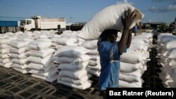 (FILE) A man carries sacks of aid for to internally displaced people in South Sudan.