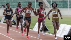 FILE - Kenyan runners Mary Moraa, right, Sarah Moraa, second from right, and Lilian Odira, center, fight for the lead in the women's 800-meter final during the Kenya Athletics Olympic Trials at Nyayo National Stadium in Nairobi, June 14, 2024.