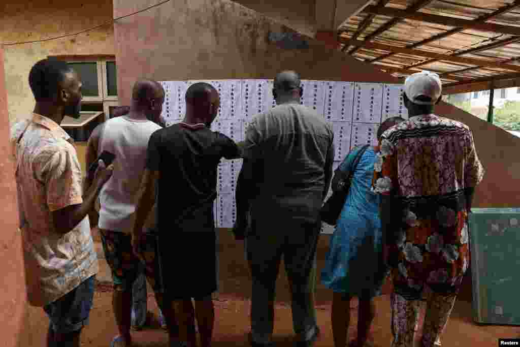 People looks for their names on voters list put up on a wall at a polling unit, during Nigeria&#39;s Presidential election in Agulu, Anambra state, Nigeria February 25, 2023.