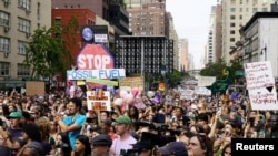 Activists listen to a speaker as they mark the start of Climate Week in New York during a demonstration calling for the U.S. government to take action on climate change and reject the use of fossil fuels, in New York City, Sept. 17, 2023.