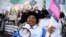 FILE - A person uses a megaphone as nurses protest during a strike by NHS medical workers, amid a dispute with the government over pay, outside University College London Hospital in London, Britain, Feb. 6, 2023.