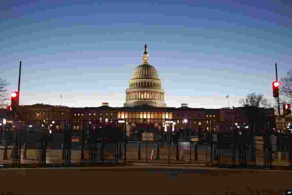 The U.S. Capitol is seen behind a security fence, March 7, 2024, in Washington, ahead of President Biden's State of the Union address.