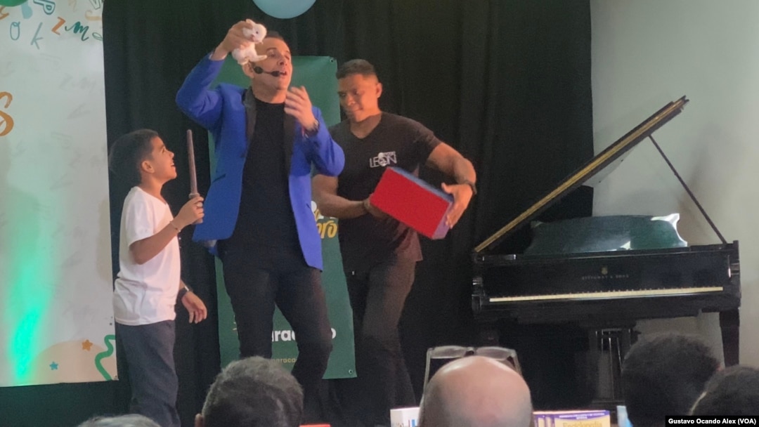 El artista conocido como "El Mago León" realiza uno de sus actos con la participación de un niño en un evento celebrado el pasado 21 de abril en el centro de aprendizaje de inglés CEVAZ, en Maracaibo, en el estado venezolano de Zulia.