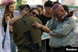 Friends and family mourn the loss of Kiril Brodski, an Israeli soldier who was killed in the October 7 attack by Palestinian Islamist group Hamas and held in Gaza until his body was recovered by Israeli forces, at his funeral in Tel Aviv, July 25, 2024.