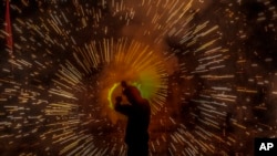 A man lights firecrackers during Dussehra festival in Srinagar, Indian-controlled Kashmir.