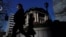 Pedestrians walk past the Bank of Japan building in Tokyo, Japan March 18, 2024. 