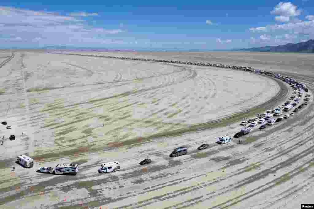 Vehicles are seen departing the Burning Man festival in Black Rock City, Nevada, Sept. 4, 2023.