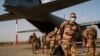 FILE - French soldiers disembark from a US Air Force C130 cargo plane at Niamey, Niger, base, on June 9, 2021. 