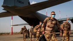 FILE - French soldiers disembark from a US Air Force C130 cargo plane at Niamey, Niger, base, on June 9, 2021. 
