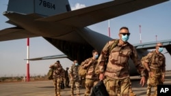 FILE - French soldiers disembark from a US Air Force C130 cargo plane at Niamey, Niger, base, on June 9, 2021.