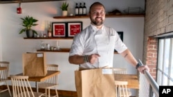 Matt Baker, chef and owner of Gravitas, is at the restaurant on Feb. 14, 2023, in Washington. (AP Photo/Jacquelyn Martin)