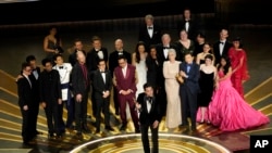 The cast and crew of "Everything Everywhere All at Once" accepts the award for best picture at the Oscars on March 12, 2023, at the Dolby Theatre in Los Angeles. 