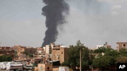 FILE - Smoke rises over Khartoum, Sudan, on June 8, 2023, as fighting between the Sudanese army and paramilitary Rapid Support Forces continued. 