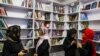 FILE - Afghan women attend the inauguration of women's library in Kabul, August 24, 2022. 