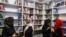 FILE - Afghan women attend the inauguration of women's library in Kabul, August 24, 2022. 