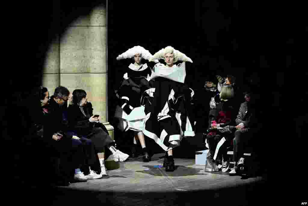 Models present creations from Comme des Garcons Womenswear Fall-Winter 2023-2024 collection during Paris Fashion Week in Paris, France, March 4, 2023.