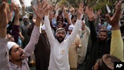 FILE - Protesters rally against a woman arrested on blasphemy charges in Lahore, Pakistan, April 17, 2023. Officials in northwest Pakistan said June 20, 2024, that a crowd stormed a police station, took a detainee facing blasphemy charges and killed him.