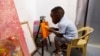 Ace-Liam Nana Sam Ankrah, who will turn 2 in July, paints at his mother's art gallery in Accra, Ghana, May 27, 2024.