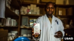 FILE - A nurse shows a box of Zidovudine — a drug prescribed to prevent the contraction of HIV/AIDS — to a patient at a USAID-supported clinic in Bunyakiri, DRC, Jan 15, 2017.