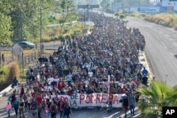 Migrants depart from Tapachula, Mexico, Dec. 24, 2023.