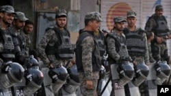 Paramilitary troops stand guard with riot gears to ensure security following angry Muslim mob attacked Christian area in Jaranwala near Faisalabad, Pakistan, Aug. 17, 2023. Police confirmed, Sept. 4, 2023, that Pastor Vicky was shot and wounded in the neighborhood.