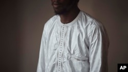 FILE - Abdoul, 32 year-old migrant from Maghama, Mauritania, poses for a photograph at his shared apartment on Oct. 6, 2023, in New York.