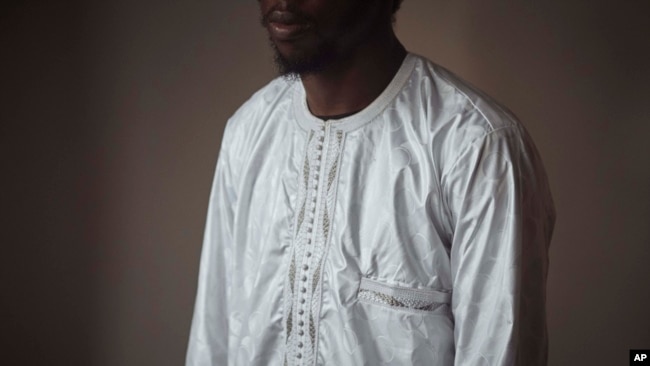 FILE - Abdoul, 32 year-old migrant from Maghama, Mauritania, poses for a photograph at his shared apartment on Oct. 6, 2023, in New York.