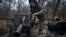 A Ukrainian serviceman of "Adam" tactical group prepares a T-64 tank to move to the positions on the front line near Bakhmut, on March 19, 2023, amid the Russian invasion of Ukraine. 