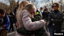 Iryna embraces her 13-year-old son Bohdan — who went to a Russian-organized summer camp from non-government controlled territories and was then taken to Russia — after he returned via the Ukraine-Belarus border, in Kyiv, Ukraine, April 8, 2023. 