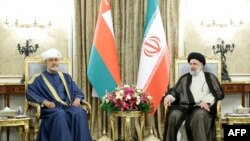 A handout picture provided by the Iranian presidency shows Iran's President Ebrahim Raisi (R) meeting with Oman's Sultan Haitham bin Tariq al-Said in Tehran, May 28, 2023. (Photo by Iranian Presidency / AFP)