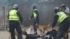 Police dogs attack a man during an anti-immigration protest in Rotherham, Britain, Aug. 4, 2024. 