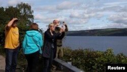 German tourists take pictures of Loch Ness as people take part in the largest Loch Ness Monster hunt in 50 years, in Scotland, Britain, Aug. 27, 2023. 