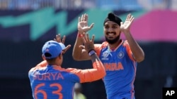 India's Arshdeep Singh, right, celebrates with Suryakumar Yadav after the dismissal of United States' Shayan Jahangir during a ICC Men's T20 World Cup cricket match at the Nassau County International Cricket Stadium in Westbury, NY, June 12, 2024.