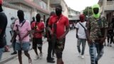 Armed members of 'G9 and Family' march in a protest against Haitian Prime Minister Ariel Henry in Port-au-Prince, Haiti, Sept. 19, 2023. 