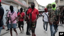 Armed members of 'G9 and Family' march in a protest against Haitian Prime Minister Ariel Henry in Port-au-Prince, Haiti, Sept. 19, 2023. 
