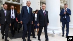 Russian President Vladimir Putin, center right, and Turkish President Recep Tayyip Erdogan, center left, leave their talks at Russia's Black Sea resort of Sochi, Russia, Sept. 4, 2023. 