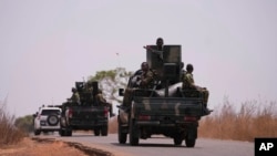 The Nigerian army patrols near a primary and secondary school where students were kidnapped, in Kuriga, Kaduna state, Nigeria, March 9, 2024. In additional attacks in the region March 16 and 17, gunmen reportedly kidnapped more than 100 people. 
