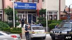 Kosovar police officers guard an office of the Postal Savings Bank from Serbia, in Mitrovica, May 20, 2024. Serbian Dinars were banned and the euro was imposed as the only legal currency, making it difficult for Kosovo Serbs to receive salaries or aid from the Serbian state. 