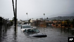 Cars are submerged on a flooded street during a rain storm in Santa Barbara, California, Dec. 21, 2023.
