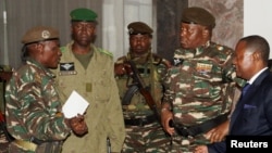 General Abdourahamane Tchiani, second from right, named the new head of state of Niger by leaders of a coup, arrives to meet with ministers in Niamey, Niger, July 28, 2023. 