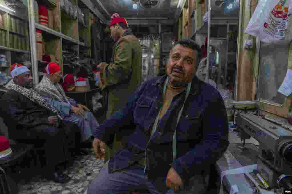Emad El-Tarabieshy, a tailor and garment shop owner, says clients "who used to buy two pieces, now only buy one. Some are also dusting off their old fez hat.” (Hamada Elrasam/VOA)