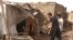 People check the rubble of their destroyed home after strikes at Allamat district in Khartoum, Sudan, June 1, 2023.