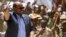 FILE: Then-Sudan President Omar al-Bashir (L) tours in a vehicle with Rapid Support Forces (RSF) paramilitaries chief Mohamed Hamdan Daglo, at the RSF headquarters in South Darfur State. Reuters reports that al-Bashir people are now backing Sudan army chief Abdel al-Burhan. 