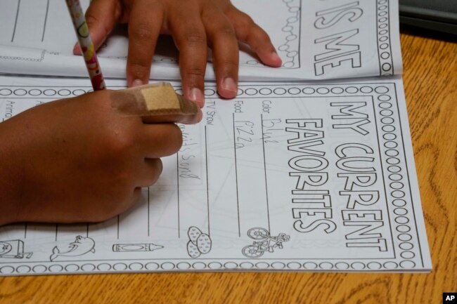 FILE - Aaliyah Ibarra works on her memory book during the last week of classes at Frye Elementary School in Chandler, Arizona Tuesday, May 23, 2023. (AP Photo/Darryl Webb)