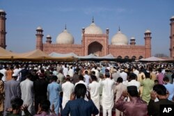 FILE—Muslims perform an Eid al-Fitr prayer, marking the end of the fasting month of Ramadan, at historical Badshahi mosque in Lahore, Pakistan, Wednesday, April, 10, 2024.